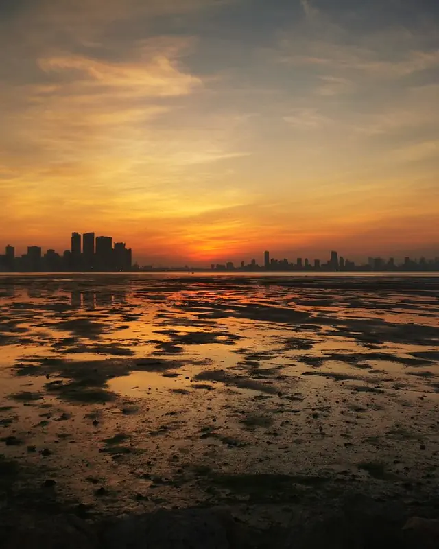 Manama skyline at sunset over the tidal flats