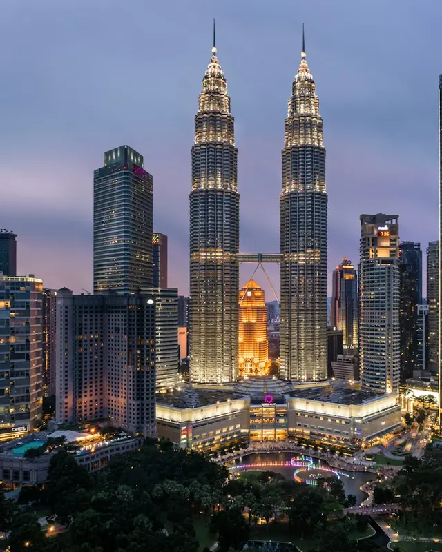 The Petronas Twin Towers lit up over Kuala Lumpur at dusk