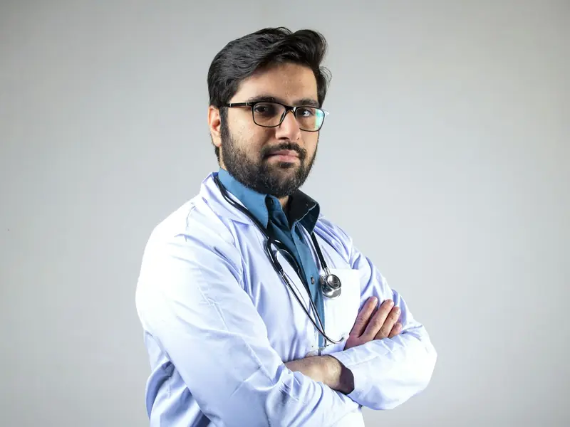 A healthcare professional in a white coat with a stethoscope